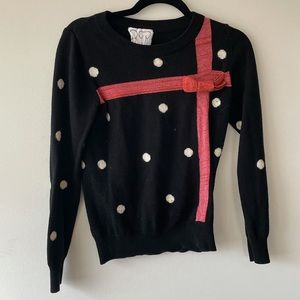 Polka dot sweater with a red bow